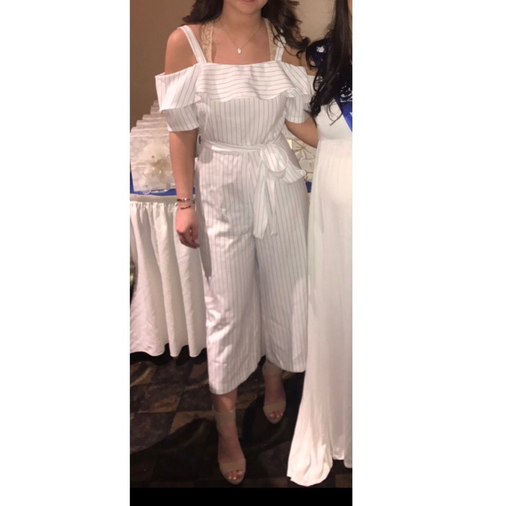 A white pin stripe off the shoulder Jumpsuit